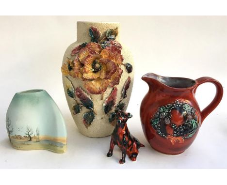 An Anita Harris glazed ceramic dog (af), marked to base, 11cmH, together with an Anita Harris jug with fruit design, 18cmH; a