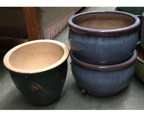 A pair of blue glazed ceramic planters, 38.5cmD, together with one other, 36.5cmD 