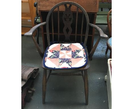 A wheelback Ercol open armchair, bears label 