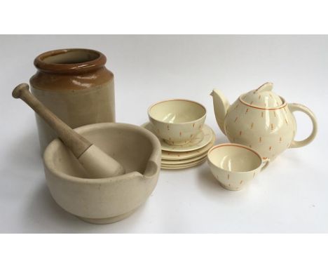 A Susie Cooper teapot, sugar bowl, saucer and five small plates with orange exclamation mark pattern, marked '1190' to base (