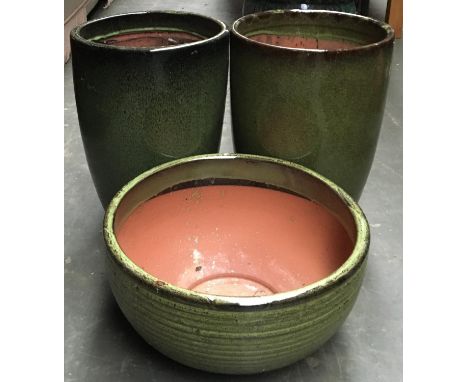 A pair of tall glazed ceramic planters, 31cmD, together with another similar, 41cmD (3) 