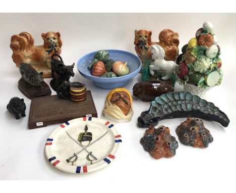 A mixed lot of ceramics to include several animal figurines, ceramic fruit baskets with fruit, a pair of Staffordshire dogs (