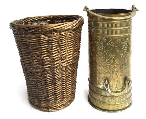 A wicker paper basket, together with a decorative brass stick stand 