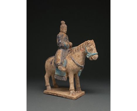 Ca. 202 BC-220 AD. Chinese Han Dynasty. Ceramic Horse with Rider. An elegant ceramic figurine depicting a grey horse in a sta