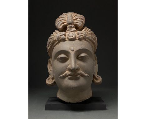 100-300 AD. Gandharan. Life-size schist head of a bodhisattva, with elaborate coiffure featuring a topknot (Ushnisha), elabor