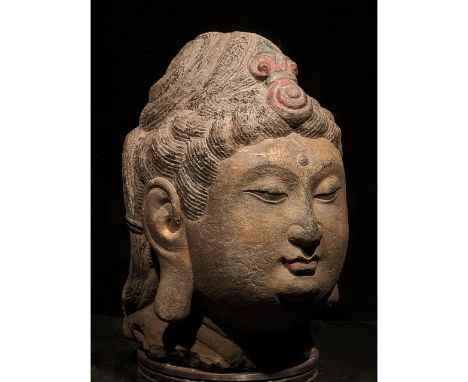 C. AD 618-907. Tang Dynasty. Stone head of Buddha with characteristic elaborate coiffured, two-tiered black “snail-shell” hai