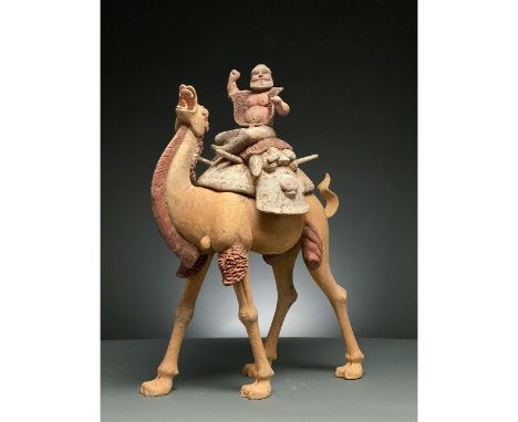 C. AD 618-907. Tang Dynasty. A large ceramic figurine of a Bactrian camel, also known as a Mongolian camel, with a rider. The