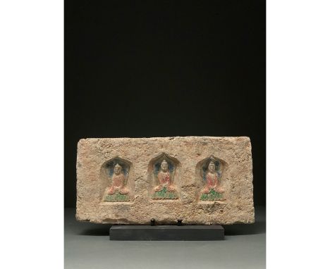 C. 386-534 AD. Northern Wei Dynasty. A brick featuring three painted Buddhas within an arched recess. All three Buddhas are w