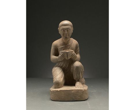 100-300 AD. Gandharan. Schist figure of a kneeling, hunched worshipper on a square base. He holds a square vessel in both han