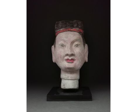 Ca. 206 BC - 220 AD. Han dynasty. A terracotta head of a warrior painted with pale skin, full red lips, and a his dark hair p