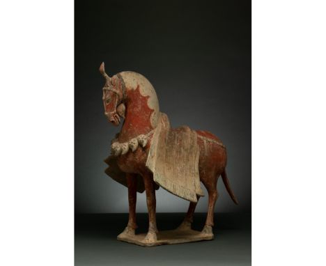 C. 386-534 AD. Northern Wei Dynasty. A painted pottery figure of a caparisoned horse. The horse stands foursquare with its he