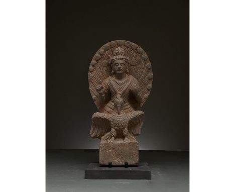 100-300 AD. Gandharan. Schist figure of Buddha atop an eagle. Buddha, backed by an intricately-incised halo, sits cross-legge