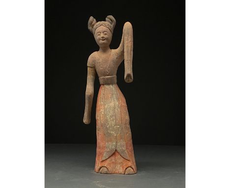 C. AD 618 and 907. Tang Dynasty. A delicate Tang Dynasty dancer wearing a long flowing gowns with overlength sleeves which hi