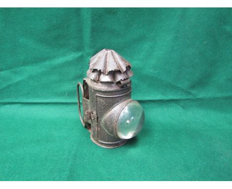 A tinware bulbous lens oil lamp 