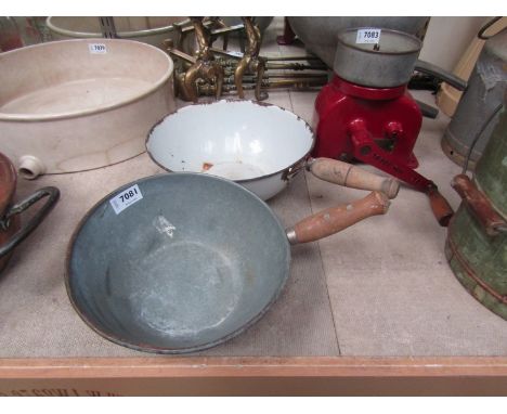 A galvanised scoop and an enamel scoop 