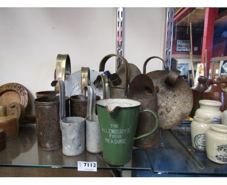 A quantity of tin and aluminium milk measures and skimmers and an enamel 'Allenbury's' food measure  