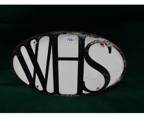 An oval enamel sign with lettering WHS for WHSmiths, 18" together with a metal wall fitting sign bracket&nbsp;