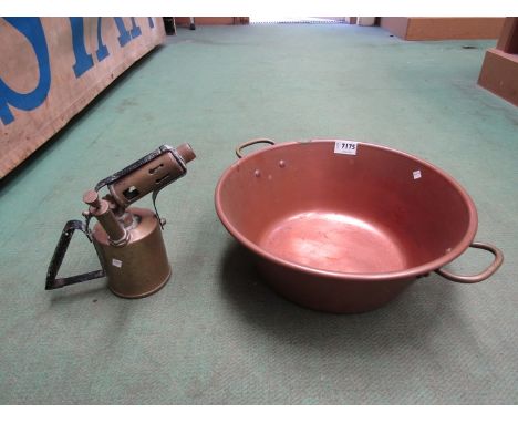 A copper twin handle bowl and brass blow lamp