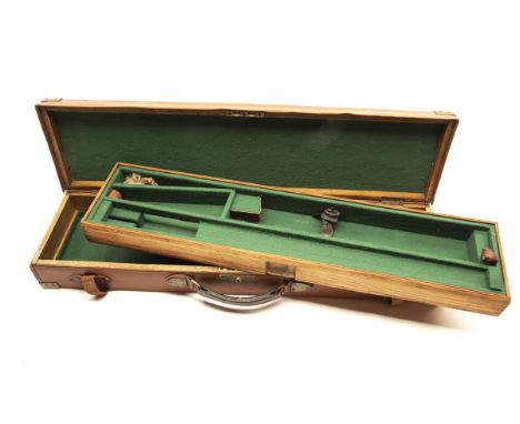 A BRASS-CORNERED OAK AND LEATHER TWO-TIER SINGLE GUNCASE, fitted for 30in. barrels, the interior lined with green baize, remo