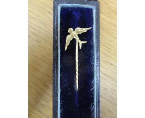 A Victorian gold coloured stick pin, the finish in the form of a swallow in flight, weight 0.9g, in original box 