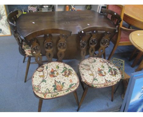 A mid 20th century dark Ercol, fall flap dining table, 28 1/4"h x 44 1/2"w and a set of four Ercol chairs designed by Lucian 