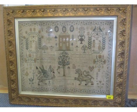 A late 18th Century tapestry decorated with dragons, Adam and Eve and having a floral border, dated 1789, 21 x 16 3/4, framed