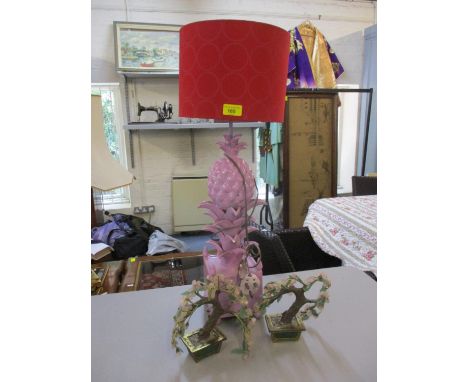 A contemporary table lamp painted lilac in the form of a pineapple having a red lamp shade, together with a pair of rose quar