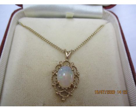 A 9ct gold and opal pendant on a 9ct gold chain 