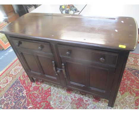 A mid 20th century dark Ercol sideboard having two drawers above two cupboard doors, 33" h x 48 1/2" 