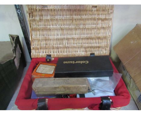A wicker hamper containing mixed bike spares etc. including bulbs and inner tubes 