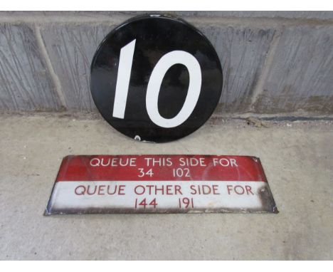 Two 1950's enamel bus signs 'Queue this side for 34,102 and Queue other side for 144,191' and a round black and white number 