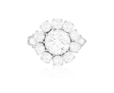 A DIAMOND CLUSTER RING, CIRCA 1960The old-cut diamond weighing approximately 2.00cts, within a similarly-cut diamond surround