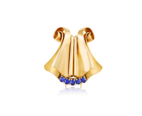 A SAPPHIRE CLIP BROOCH, BY CHAUMET, CIRCA 1940The undulating scrolls with a row of cushion-cut sapphire highlights, mounted i