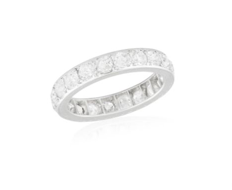 AN EARLY 20TH CENTURY DIAMOND ETERNITY RING, CIRCA 1920The continuous row of old brilliant-cut diamonds, the sides of the hoo