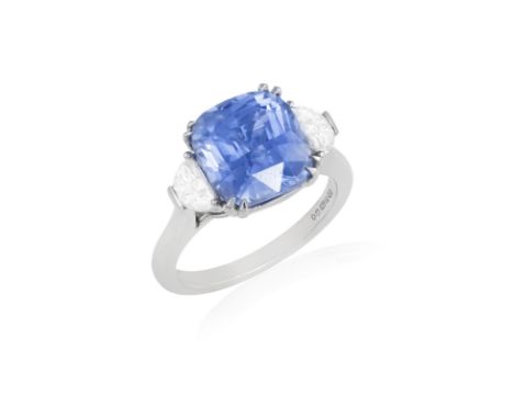 A SAPPHIRE AND DIAMOND DRESS RINGThe central cushion-shaped sapphire weighing 5.59cts within a four-claw setting and between 