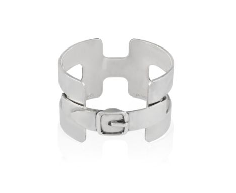 A SILVER BANGLE, BY HERMÈS, CIRCA 1970The openwork cuff of stylised H design, with hinged buckle clasp to the front, in silve