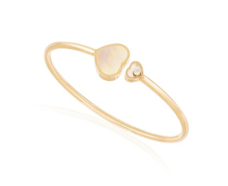 A DIAMOND AND MOTHER-OF-PEARL 'HAPPY HEARTS' BRACELET, BY CHOPARDThe thin polished gold bangle, one terminal with glazed hear