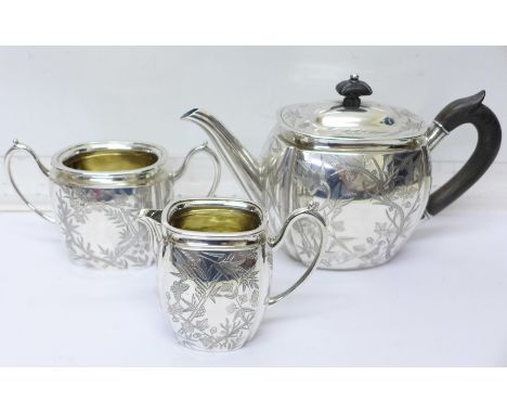 A three piece Victorian silver tea service, London 1880, William Hutton &amp; Sons, with monogram, 703g, with fitted case