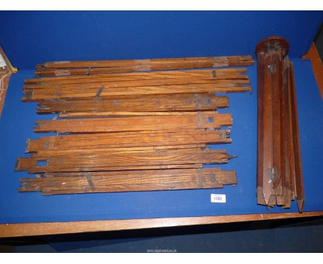 A quantity of vintage wooden camera tripods.