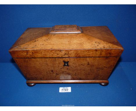 A Walnut sarcophagus Tea Caddy, standing on four bun feet, one handle missing, 12" wide x 7" x 7" deep, with brown glass bowl