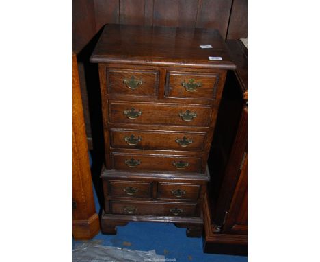 An appealing compact Oak chest on chest design chest having four long and four short drawers, 17 1/2'' wide x 13'' deep x 33 