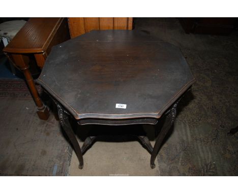 A Mahogany octagonal occasional table standing on cabriole legs united by a lower shelf, 29 3/4'' diameter x 28 3/4'' high.
