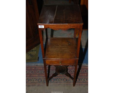 A Georgian Oak campaign Washstand, the square legs united by a lower shelf and a drawer and a cross stretcher with a central 