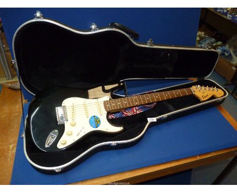 A Squire Stratocaster Guitar with lead (a nice versatile guitar allowing for the switch between playing rhythm and lead), wit