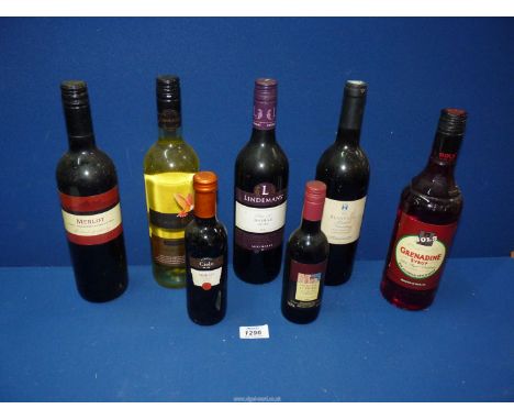 Three bottles of red wine and one white, a bottle of Grenadine syrup and two small bottles of red wine.