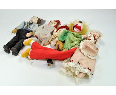 A group of large, generally vintage, puppet dolls of various outfits including ventriloquist character puppet and one other. 