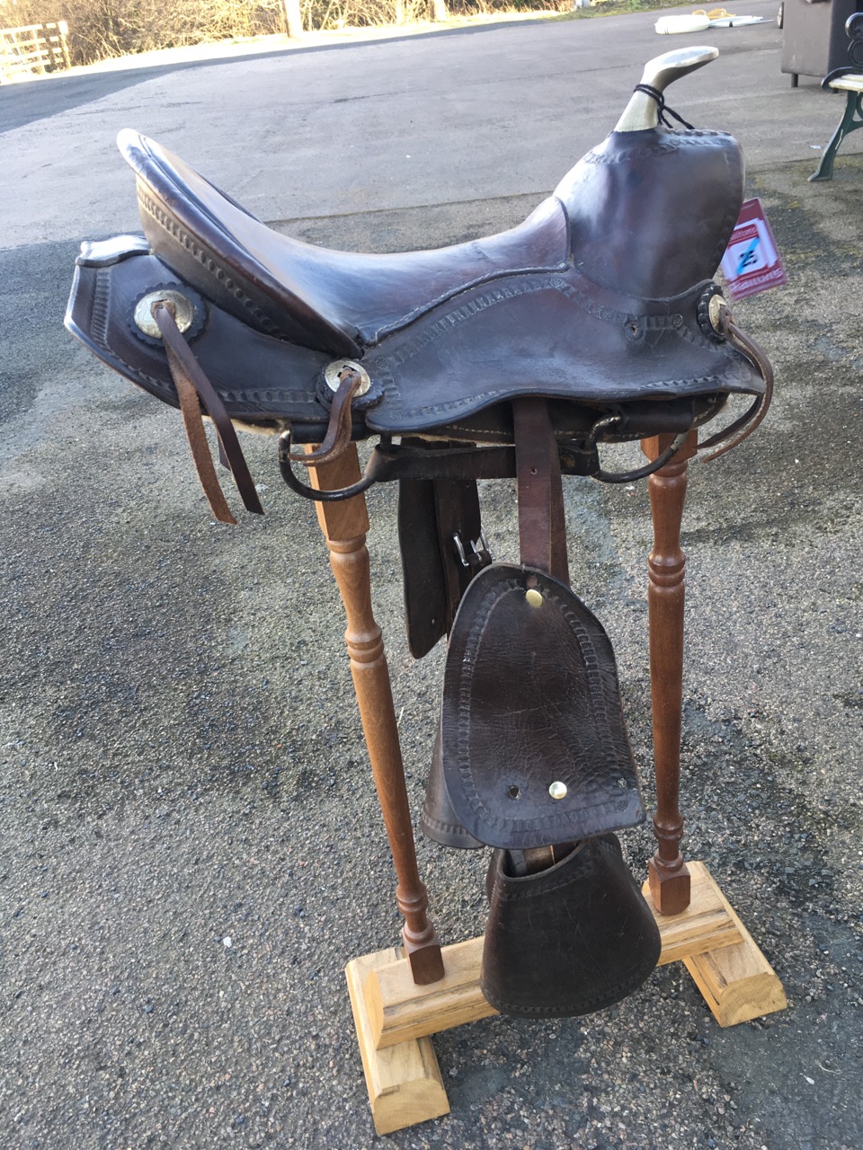 A childs western style saddle with silver plated pommel, wood stirrups