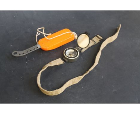 A WRIST ESCAPE COMPASS MARKED 6B/2593 ON ORIGINAL CANVAS STRAP (THE TYPE USED BY RAF AIR CREW), together with an RAF dinghy k