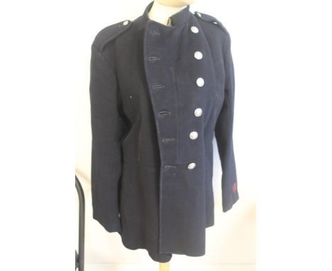 FIRE BRIGADE INTEREST, a black Fireman's tunic made by James Smith and Co, a brass hose nozzle, brass cap, belt, and axe
