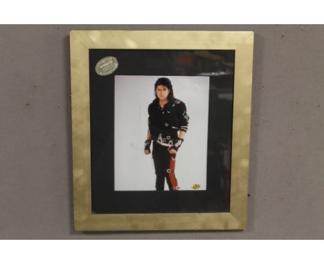 A FRAMED PHOTOGRAPH OF MICHAEL JACKSON BEARING SIGNATURE, with Sportizus Ltd certificate of authenticity affixed to the back 